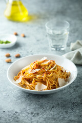 Spaghetti with red pesto sauce and cheese