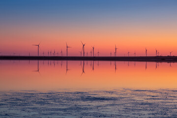 Fototapeta premium wind turbines at sunset. amazing landscape