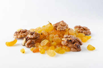 Closeup of dried sultana grape, walnuts on the white background