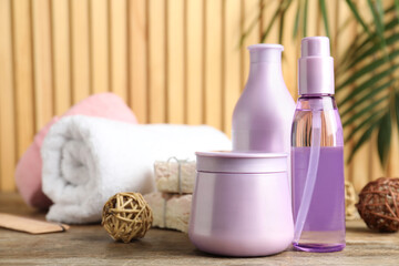 Set of hair care cosmetic products on wooden table