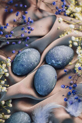 Happy Easter card with blue eggs,flowers,feathers