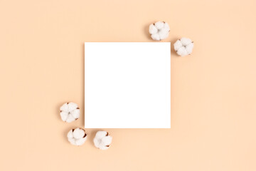 Square paper card mockup with frame made of cotton on a beige background. Eco concept.