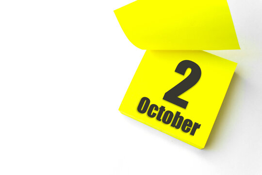 October 2nd. Day 2 of month, Calendar date. Close-Up Blank Yellow paper reminder sticky note on White Background. Autumn month, day of the year concept.