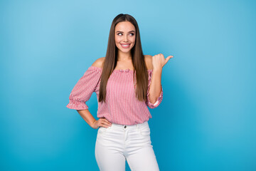 Portrait of cheerful girl point forefinger copyspace indicate ads discount wear red outfit isolated over blue color background