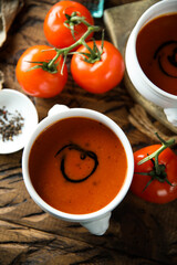 Homemade spicy tomato soup in a white bowl