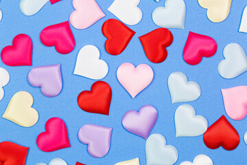 Decorative colourful is small heart blue background. Many colorful silk hearts - valentine background 