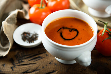 Homemade spicy tomato soup in a white bowl