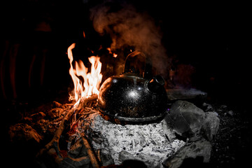 iron kettle stands on the coals of fire
