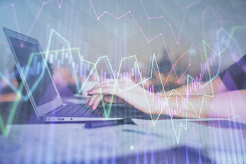 Double exposure of businesswoman hands typing on computer and forex chart hologram drawing. Financial analysis concept.