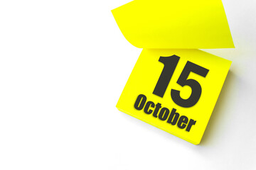 October 15th. Day 15 of month, Calendar date. Close-Up Blank Yellow paper reminder sticky note on...