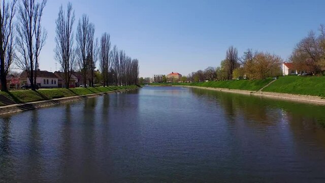Aerial view of Bosut river crossing Vinkovci city during summer day, Croatia.