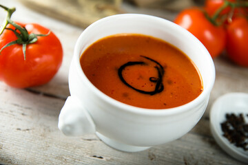 Homemade spicy tomato soup in a white bowl