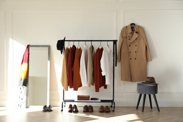 Rack with stylish clothes in modern dressing room