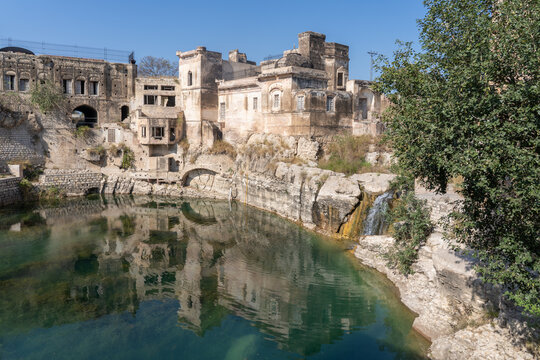 View of ancient Katas Raj hindu shiva temples with reflection on sacred pond in Chakwal, Punjab, Pakistan