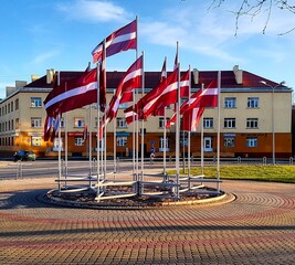 decoration of latvian flags in the city center in valmiera, latvia - obrazy, fototapety, plakaty
