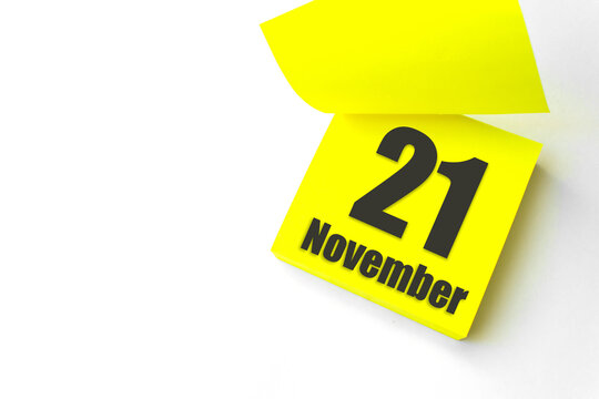 November 21st . Day 21 of month, Calendar date. Close-Up Blank Yellow paper reminder sticky note on White Background. Autumn month, day of the year concept.