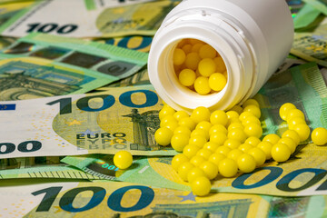 Pills of vitamin C spilled on Euro currency