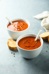 Homemade spicy tomato soup in a white bowl