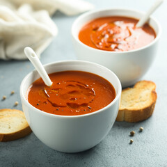 Homemade spicy tomato soup in a white bowl