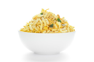Crunchy Murmura in a white Ceramic bowl, made with Puffed Rice and Curry leaves. Pile of Indian spicy snacks (Namkeen), under backlight, Front view, against the white background.