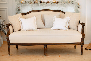 Classic sofa with cushions, light upholstery, wooden base. Eco-friendly materials.