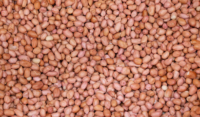 Seasoning peanuts pink brown shelled in marker. Background from ripe peeled peanut closeup.