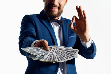 a man in a classic suit with a wad of money banknote business finance model