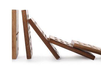 Wooden domino tiles falling on white background