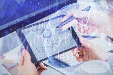 Double exposure of man's hands holding and using a phone and financial chart drawing. Market analysis concept.