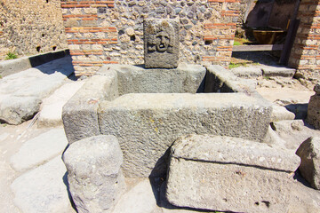 Drinking fountain found in the ruins of the archaeological site of Pompeii, Campania, Italy. Roman...