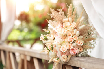 Creative wedding bouquet on wooden railing