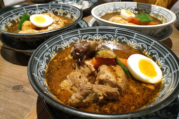Soup curry with chicken, pork and vegetables. Famous food in Hokkaido, Japan.