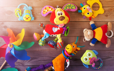Obraz premium Set of toys for newborn on wooden background. top view