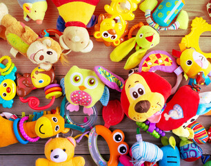 Fototapeta na wymiar Set of toys for newborn on wooden background. top view