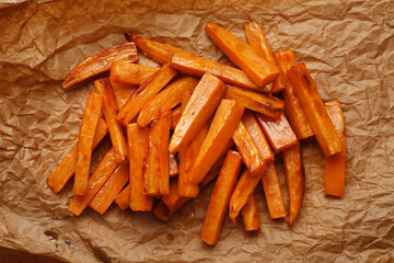 Fried sweet potatoes with sauce on the background