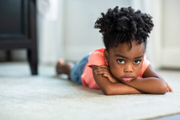Young African American little girl upset and pouting.