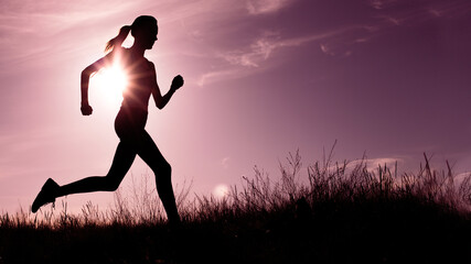 silhouette of athlete running against sunset sky background
