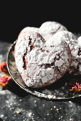 Tasty heart shape form cookies on background table. Homemade red cookie with sugar icing. St.Valentine sweets. Close up view delicious sweet dessert