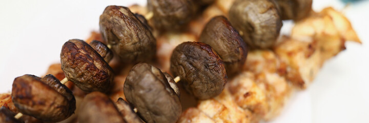 Ready meat on skewers with mushrooms. Cooking at home concept