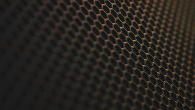 Zoom on abstract background Protective decorative metal grill with honeycombs on modern acoustic systems.