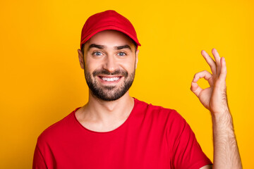 Close-up portrait of nice cheerful guy skilled content mailman showing ok-sign ad isolated over bright yellow color background