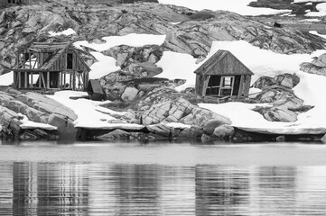 Greyscale shot of an abandoned village, on an island at Disko Bay, Greenland during winter