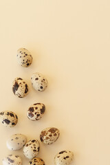 Quail eggs on a beige background. Top view. Easter decoration. Mockup. With copy space for text  