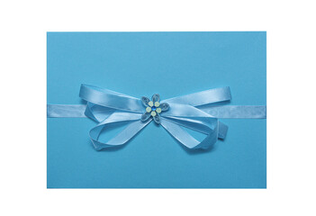 Blue envelope with ribbon and flower isolated on white background.