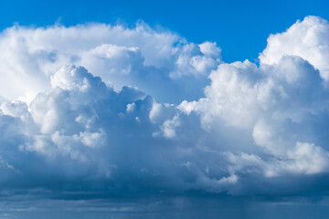 Blue sky with white thunder clouds