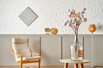 Cotton flower in the glass vase on the table, modern decorative wall room background style.