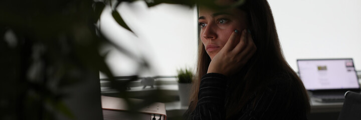 Young woman works at laptop late at night. Recycling working time concept.