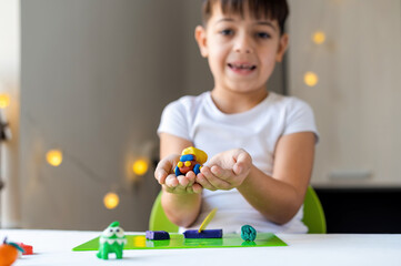 Small boy playing with plasticine