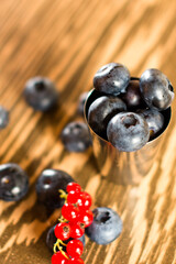 Composition with black and red guide, sweet and healthy summer berries, blueberries and red currants.