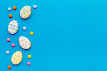 Top view of Easter cookies eggs and sweets. Space for text